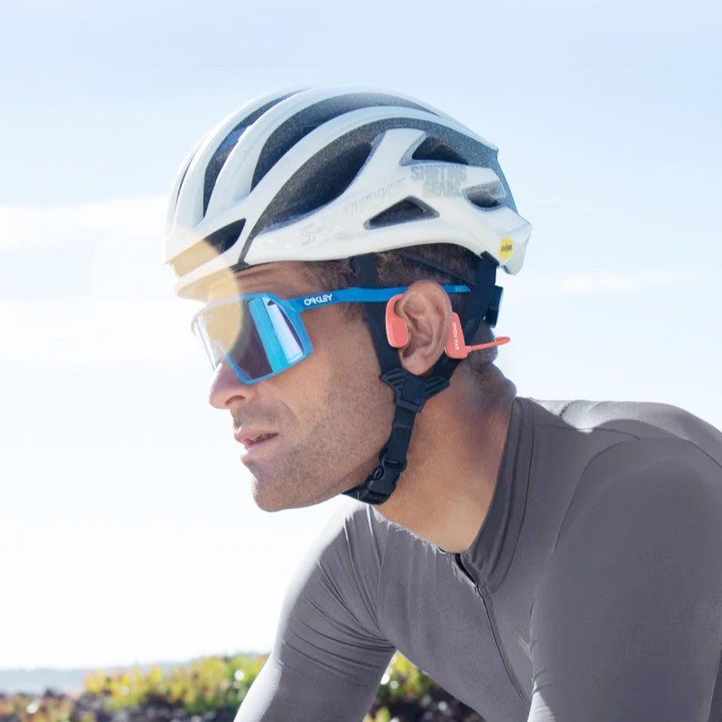 Cyclist wearing a helmet and sunglasses with a blurred background
