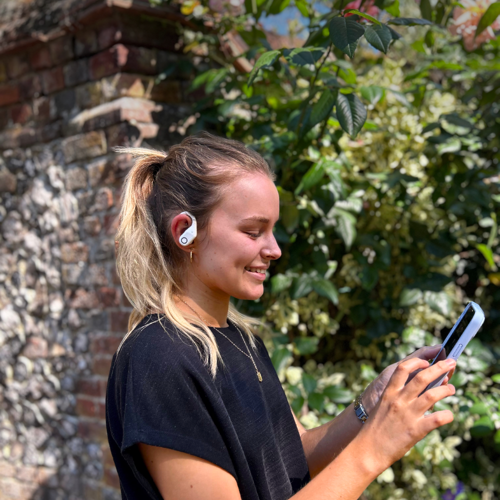 person wearing open ear bone conduction headphones